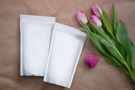 Beautiful spring bouquet with a pack of coffee for your decoration. Template for your brand on the...