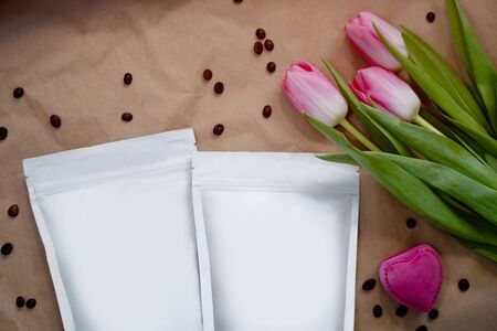 Beautiful spring bouquet with a pack of coffee for your decoration. Template for your brand on the packaging. Layout for the design of your logoの写真素材