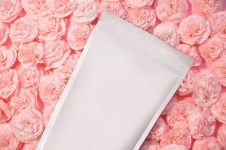 Paper packaging template on paper flowers background. Mocap for branding your product on the package. Stock photo for designの写真素材