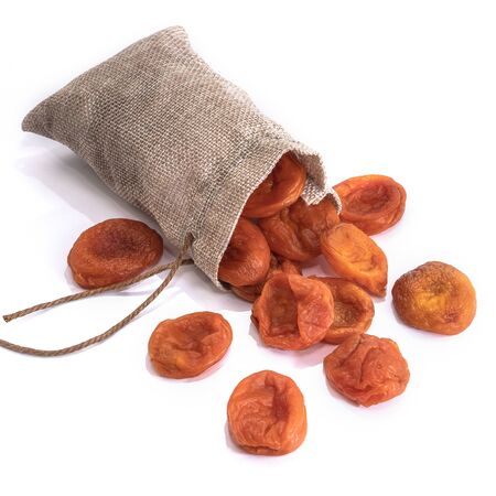 Dried apricots on a white isolated background. Delicious raisins food yellow for your design for the site. kitchen themeの写真素材