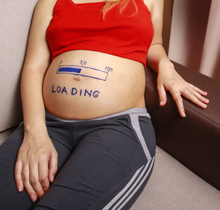 Pregnant with a big belly and a pattern on it. Fifty percent load. Half of the pregnancy has already...