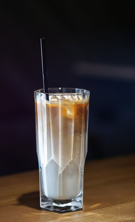 Coffee drink in a glass cup. Latte on a dark background in a cafe. Business stock photo for designの写真素材