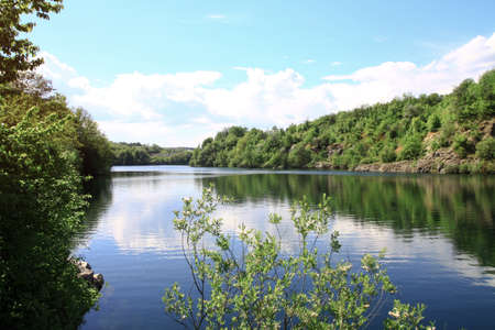 Beautiful river in the highlands in summer. Lake in an ecologically clean park reserve on a background of hills. A pretty landscape in the spring. Stock photo for designの写真素材
