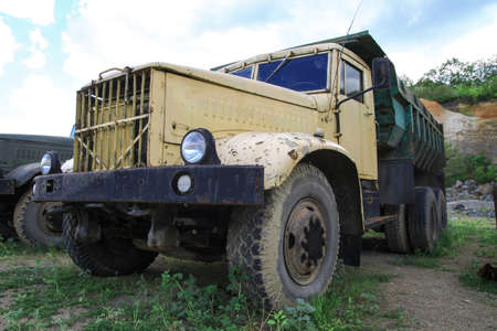 Old truck in very poor condition. A car stands in nature like abandoned metal rubbish. Stock photo background for design.の写真素材