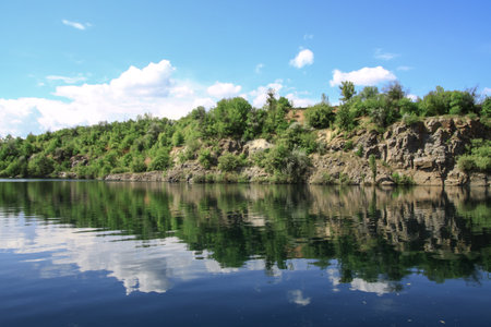 Beautiful river in the highlands in summer. Lake in an ecologically clean park reserve on a background of hills. A pretty landscape in the spring. Stock photo for designの写真素材