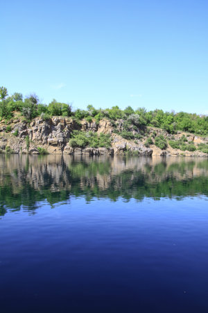 Beautiful river in the highlands in summer. Lake in an ecologically clean park reserve on a background of hills. A pretty landscape in the spring. Stock photo for designの写真素材
