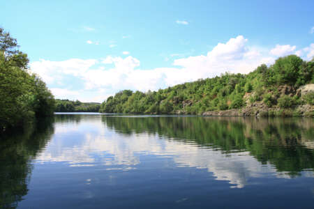 Beautiful river in the highlands in summer. Lake in an ecologically clean park reserve on a background of hills. A pretty landscape in the spring. Stock photo for designの写真素材