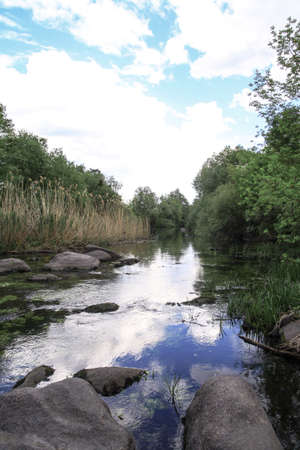 Beautiful river in the highlands in summer. Lake in an ecologically clean park reserve on a background of hills. A pretty landscape in the spring. Stock photo for designの写真素材