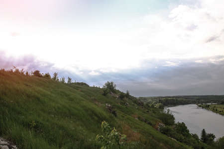 Nice big mountain river with a beautiful view. A rock on the side of a brook. Stock landscape for designの写真素材