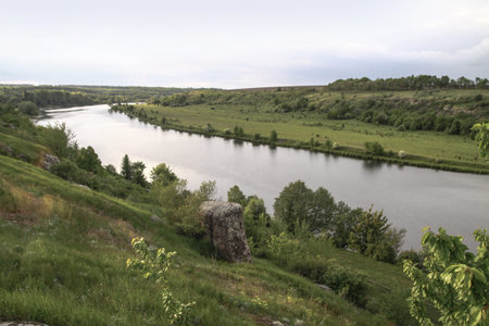 Nice big mountain river with a beautiful view. A rock on the side of a brook. Stock landscape for...