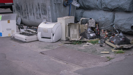 Discarded computer equipment in a landfill. Printers monitors and computers. Environmental...