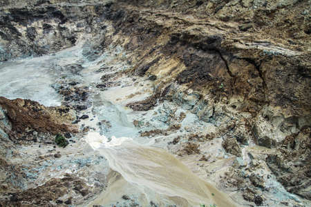 Dug hole in the ground is filled with water to the level. Swamp from the element that destroyed human activity. Stock abstract backgroundの写真素材