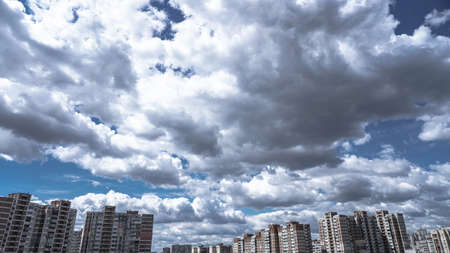 Apartment buildings on a background of beautiful clouds. High-rise buildings are built with panel construction in which people live. Stock photo backgroundの写真素材