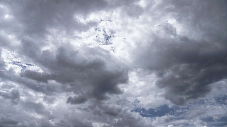 Picturesque clouds in the sky. Window view of an airplane on a sunny gloomy day. Stock photo backgroundの写真素材