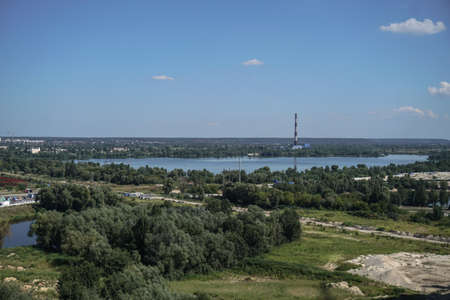 Outskirts of the city industrial zone on the background of a river or lake. Stock photo for designの写真素材