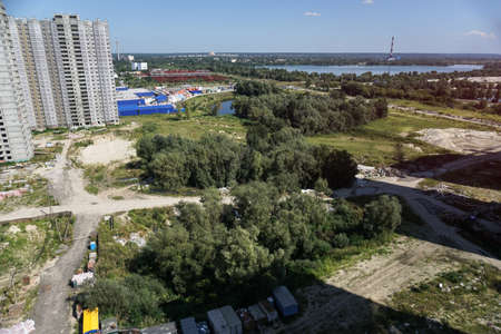 Large construction site on a background of blue sky. Brick, panel apartment building. Industrial theme for designの写真素材