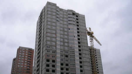Large construction site on a background of blue sky. Brick, panel apartment building. Industrial theme for designの写真素材