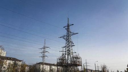High voltage pole with wires through which electricity flows. Power lines and substations for...