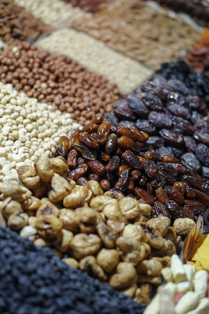 Rack on the market with dried fruits and nuts and Turkish sweets. Vegetarian food mix. Stock photo...