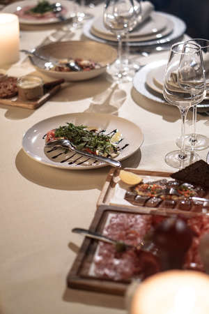 Nicely served New Year's table in the restaurant. Christmas night in a cafe or at home. Stock photo for designの写真素材