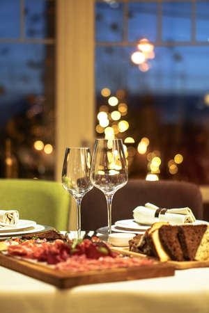 Nicely served New Year's table in the restaurant. Christmas night in a cafe or at home. Stock photo for designの写真素材