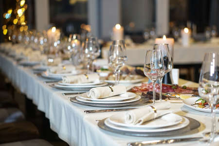 Nicely served New Year's table in the restaurant. Christmas night in a cafe or at home. Stock photo for designの写真素材