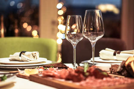 Nicely served New Year's table in the restaurant. Christmas night in a cafe or at home. Stock photo for designの写真素材