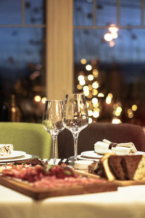 Nicely served New Year's table in the restaurant. Christmas night in a cafe or at home. Stock photo for designの写真素材