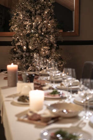 Nicely served New Year's table in the restaurant. Christmas night in a cafe or at home. Stock photo for designの写真素材