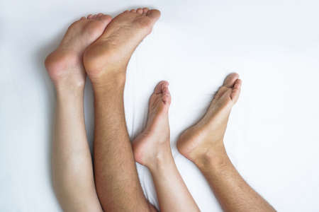 Love between a man and a woman with naked bodies. having sex in a white bed. Intimate background themeの写真素材