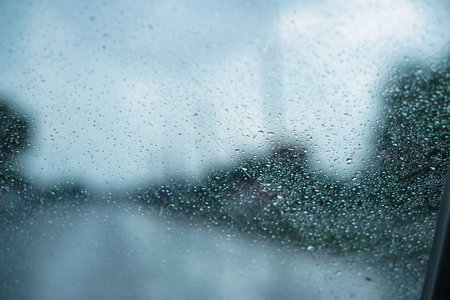 Car glass in drops from rain. Autumn summer rain through the car window. Photo backgroundの写真素材