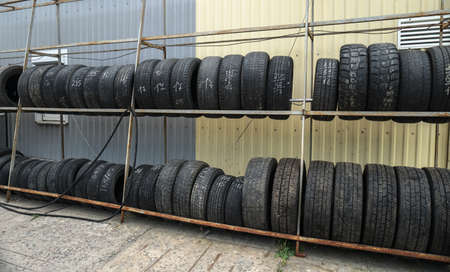 Used car tires at a recycling plant. wheels for trucks. Background for environmental themeの写真素材