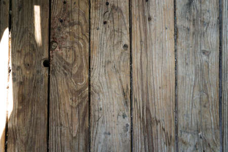 Old board in erased paint. Wooden wall of an old building. Background for design.の写真素材