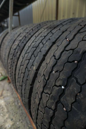 Used car tires at a recycling plant. wheels for trucks. Background for environmental themeの写真素材
