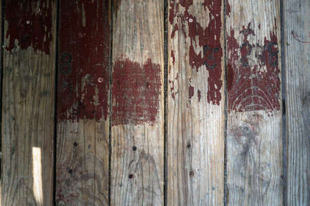 Old board in erased paint. Wooden wall of an old building. Background for design.の写真素材
