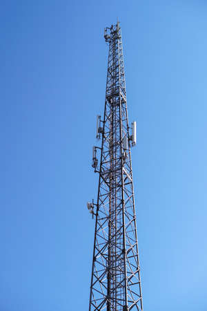 Telephone station transmitting gsm mobile signal. Tower transmitting 5g, 4g internet around the world. Pollution of the natural environmentの写真素材