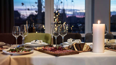 Nicely served New Year's table in the restaurant. Christmas night in a cafe or at home. Stock photo for designの写真素材
