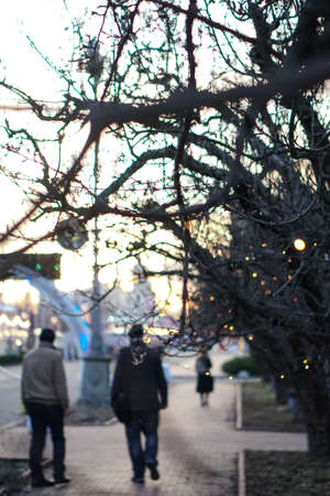Beautiful street view with garlands and bokeh on the background. Christmas background for design. New Year's atmosphere in Europeの写真素材