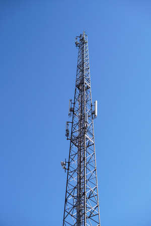 Telephone station transmitting gsm mobile signal. Tower transmitting 5g, 4g internet around the world. Pollution of the natural environmentの写真素材