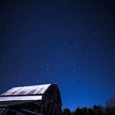 Rural Log Cabin barn at night with stars and milky way, and snow and trees on an Ontario farmの写真素材