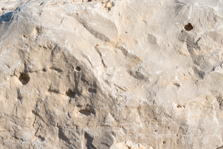Closeup limestone rock face showing weathered strata for a greologival, natural wallpaper or...