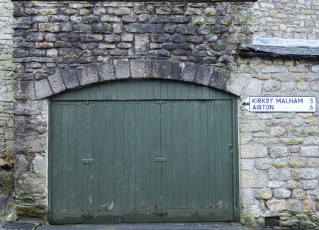 Old countryside doorway framed by aged masonry blocks.