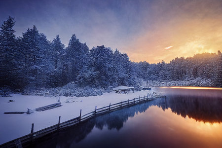 Frozen lake in winter forest at sunset. Beautiful winter landscape.の素材