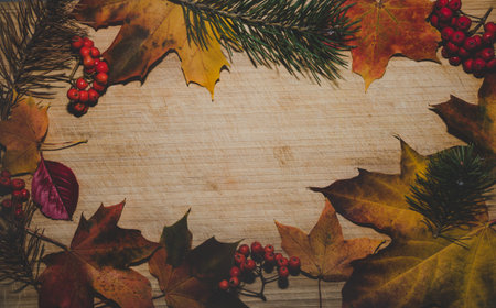 autumn background with colored leaves on wooden board