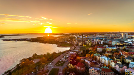 Aerial view of beautiful city Helsinki at sunset time. Blue sky and clouds and colorful buildings....