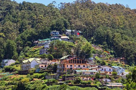 Nuwara Eliya, Sri Lanka. Circa 2016. A beautiful scenic view of residential buildings and houses on a sloping hill in the middle of a forest.の写真素材