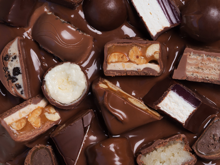 Different cut chocolate bars in melted chocolate. Top ofview, close-up.の写真素材