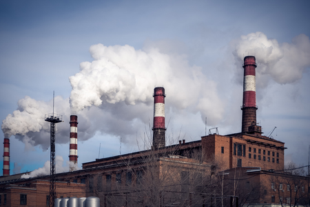 Smoke from pipes heat power station. Environmental pollution.  の写真素材