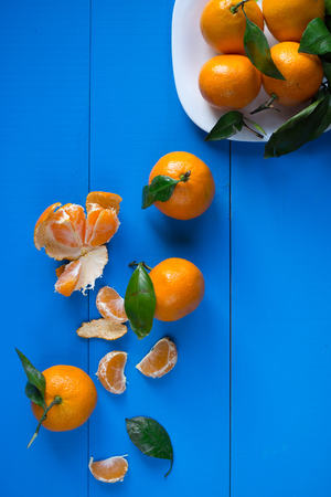 Mandarins on a blue wooden background, verticalの写真素材