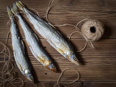 Dried fish on a wooden table.の写真素材